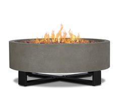 an outdoor fire pit is shown with flames coming out of the top and on it's sides