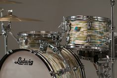 a close up of a drum set on a gray background with white and yellow stripes