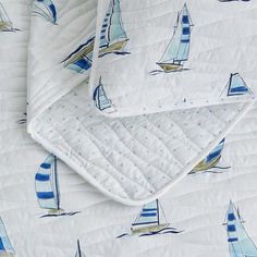 a quilted bed with sailboats on it