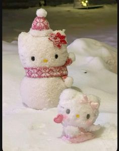 a hello kitty snowman and her baby doll are posed in front of the snow