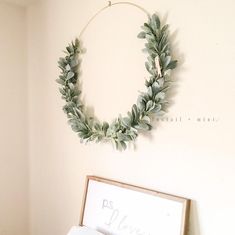 a wreath hanging on the wall above a bed