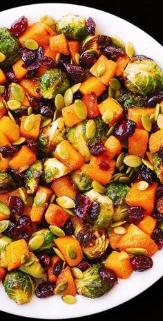 brussel sprouts, brussels sprouts and cranberries on a white plate