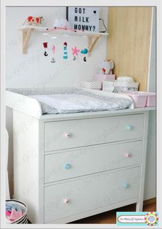 a baby crib with drawers and toys on it