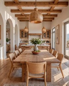 a large wooden table sitting in the middle of a kitchen