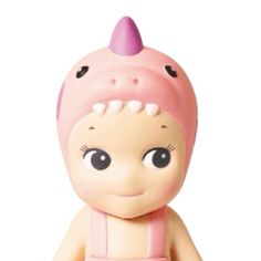 a small toy doll with big eyes and a pink hat on it's head