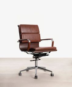 an office chair with brown leather upholstered to the seat and back, on casteors