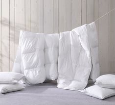 white pillows and pillow cases on a bed