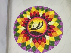 a colorful flower design on the ground with a palm tree in it's center