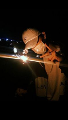 a person holding a sparkler in the dark