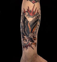 a man's leg with an eagle tattoo on it