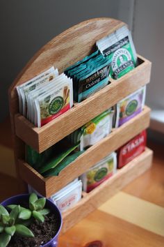 a wooden holder with plants and snacks in it