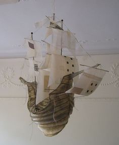 a model ship is hanging from the ceiling