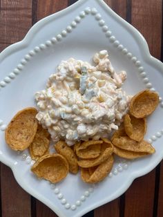 a white plate topped with chips and dip