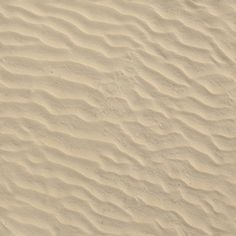 the white sand is textured with small waves and lines on it's surface