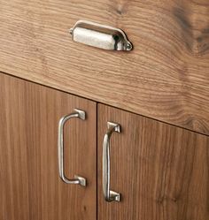 a wooden cabinet with two metal handles on it