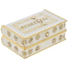 a white and gold box with flowers on it