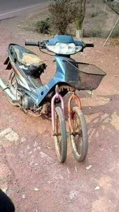 a blue motorcycle parked on top of a dirt road