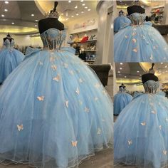 a blue ball gown with butterflies on the bouncy skirt and bustle is shown