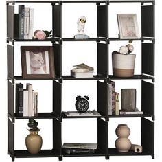 a book shelf filled with books and vases on top of eachother in front of a white background