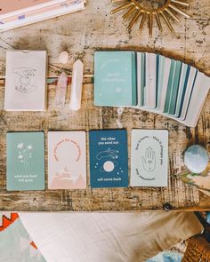 some cards are sitting on a table with other items around them and a sunburst in the background