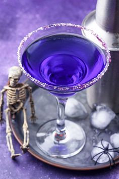 a purple drink sitting on top of a metal tray