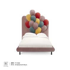 an upholstered bed with balloons on the headboard and foot board is shown