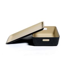 two black and gold trays sitting next to each other