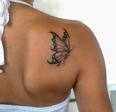 a woman with a butterfly tattoo on her back