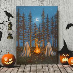 two carved pumpkins sitting next to each other on a wooden table with halloween decorations