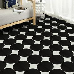 a black and white polka dot rug in a living room