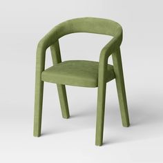 a green chair with a curved back and arm rests on an isolated white surface in front of the camera