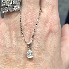 a woman's hand with two rings on it and a diamond ring in the middle