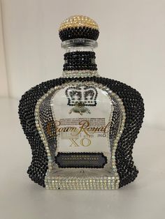 the bottle is decorated with black and white beads, which are embellishments