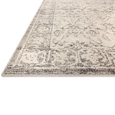 a white rug with an intricate design on the top and bottom, along with a black border