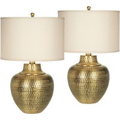 two gold vases with white lamps on each one and a beige shade for the lamp