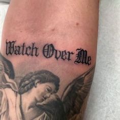 a tattoo with an angel and the words watch over me on it's arm