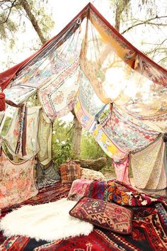 a bed covered in lots of pillows under a canopy with a quote above it that reads,