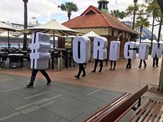 some people are walking down the street with giant letters in front of them that spell out organ