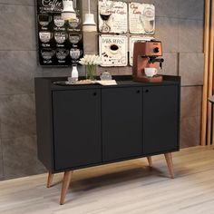 a black cabinet sitting on top of a hard wood floor next to a wooden table