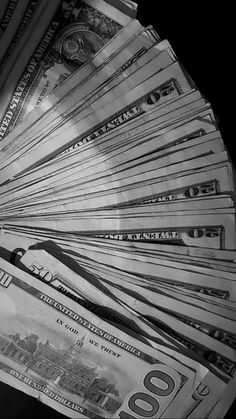 a pile of twenty dollar bills sitting on top of each other in black and white