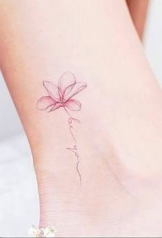 a pink flower tattoo on the ankle