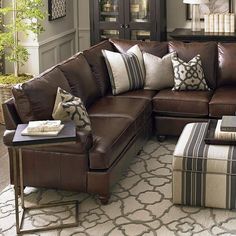 a living room filled with lots of furniture and decor on top of a white rug