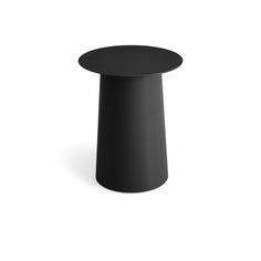 a black round table sitting on top of a white floor