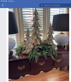 a christmas tree is sitting on top of a dresser