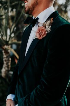 a man in a tuxedo looks off into the distance