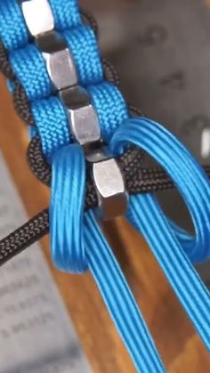 a close up of a blue rope with metal clasps on it's end