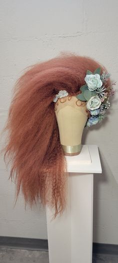 This wig made of synthetic material. It comes with a lace front and baby hairs. The flowers are made of silk. This wig can be made in many colors. Contact me for options. I take a lot of time creating these wigs and the last thing I want is for it to arrive a mess. I take extra care when packing and shipping your wig. Your wig will be shipped on a styrofoam head. I place those heads in the center of the box and use wire to secure it to the bottom. This keeps the head from being able to move around in the box and your wig to stay untouched in travel. I include a piece of polyester fabric, I recommend storing your wig with this covering it. This will help keep dust from settling on your fabulous wig. There is an option to purchase a canvas wig block and wooden stand that was hand crafted by Styrofoam Head, Baby Hairs, Wig Making, Knoxville Tn, Synthetic Materials, Wooden Stand, Baby Hairstyles, Lace Front, Polyester Fabric