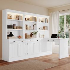 a white desk and bookcases in a room