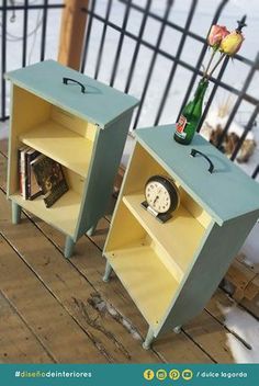 two side tables with books and magazines on them in front of a black iron fence