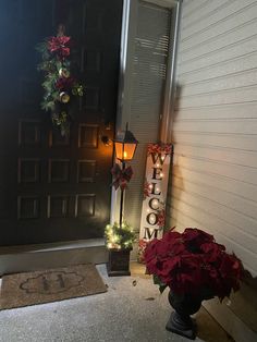 the front door is decorated for christmas with lights and poinsettis on it